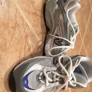 New balance shoe. White, silver, and navy blue.